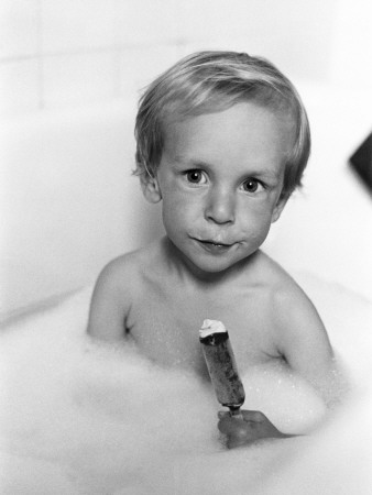Boy Eating An Ice-Cream While Taking A Bath by Lars Hesselmark Pricing Limited Edition Print image