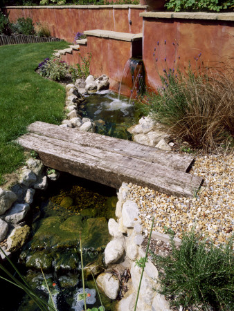 Petersfield Garden Wooden Bridge Over Stream With Rendered Wall, Designer: Mark Laurence by Clive Nichols Pricing Limited Edition Print image