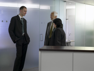 Office Life And Interiors, Businesspeople Talking by Richard Bryant Pricing Limited Edition Print image