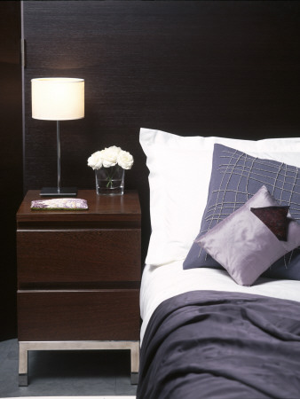 Hotel Chic, Modern Bedroom Detail With Pillows, Dark Timber And Bedside Lamp by Richard Powers Pricing Limited Edition Print image