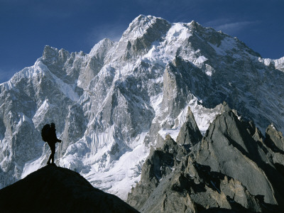 A Man Stands Silhouetted Against The Karakoram Mountains, Pakistan by Jimmy Chin Pricing Limited Edition Print image