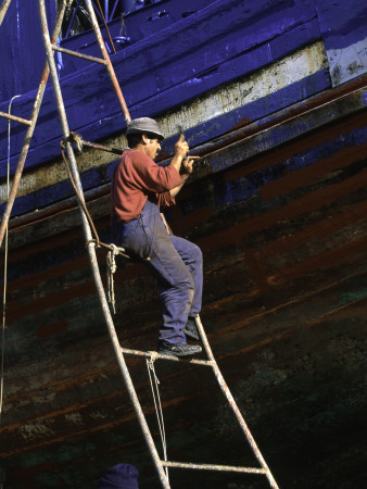 Man On Ladder Repairing Boat, Morocco by Michael Brown Pricing Limited Edition Print image