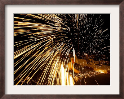 A Palestinian Boy Plays With A Homemade Sparkler by Muhammed Muheisen Pricing Limited Edition Print image