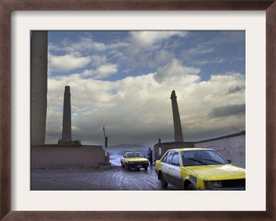 Taxis Pass A Guard In Herat, Afghanistan, In This December 7, 2001 Photo by Kamran Jebreili Pricing Limited Edition Print image