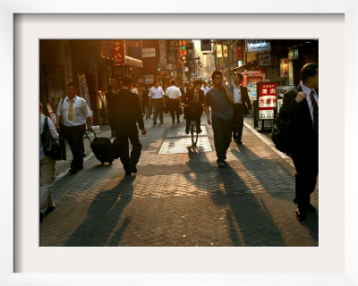 Japanese Commuters Walk Through A Tokyo Street On Their Way To The Train Stations by David Guttenfelder Pricing Limited Edition Print image
