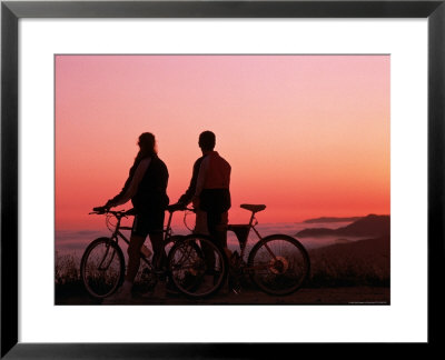 Silhouette Of Two Cyclists At Sunset by Paul Meyer Pricing Limited Edition Print image
