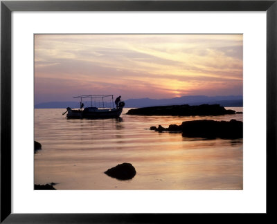 Fishing Boat In St. Thomass Bay At Pefkos At Sunset, Greece by Ian West Pricing Limited Edition Print image