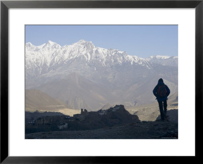 Trekker At Dawn Looking Out Over The Old Fortified Village Of Jharkot On The Annapurna Circuit Trek by Don Smith Pricing Limited Edition Print image