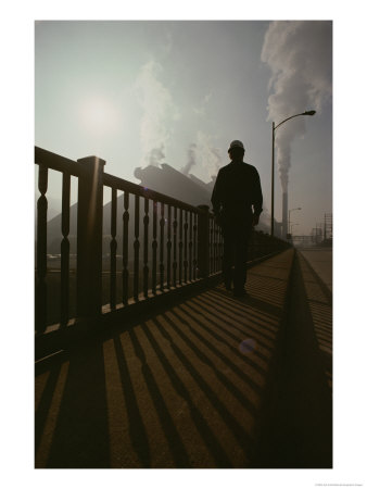 A Silhouetted Man Walks Towards An Industrial Area by Jodi Cobb Pricing Limited Edition Print image