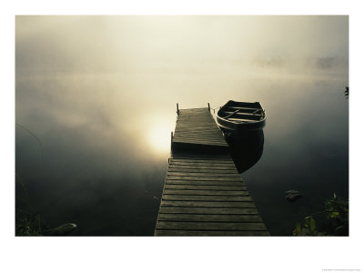 The Morning Sun Shines On A Rowboat Tied To A Dock by Stephen Alvarez Pricing Limited Edition Print image