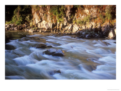 The Payette River Flows By With Lit Rock Wall Behind, Idaho, Usa by Brent Bergherm Pricing Limited Edition Print image