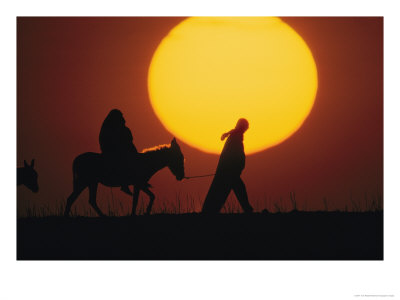 Silhouetted Man Leads A Donkey Bearing A Pregnant Woman, Reminiscent Of Joseph And Mary, Israel by Tom Nebbia Pricing Limited Edition Print image