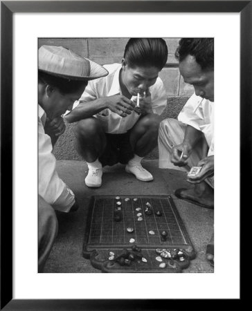 Boys Playing Board Game On Sidewalk In Front Of The Trocadero Hotel by Dmitri Kessel Pricing Limited Edition Print image