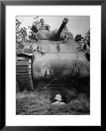 Oncoming View Of Tank About To Pass Over Foxhole In Which A Soldier Is Crouched Down by Myron Davis Pricing Limited Edition Print image