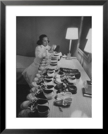 Mrs. Ottilie King Lining Up Her Children's Shoes by Stan Wayman Pricing Limited Edition Print image