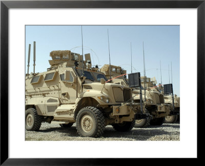 Mine Resistant Ambush Protected Vehicles Sit In The Parking Area At Joint Base Balad, Iraq by Stocktrek Images Pricing Limited Edition Print image