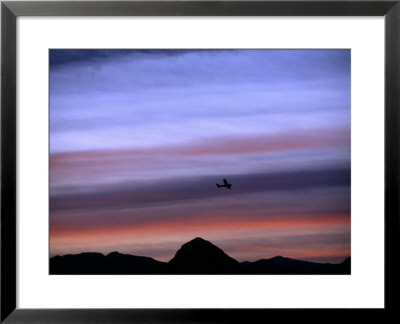 Aircraft And Mountains Silhouetted Against A Dramatic Sky At Dusk, Wyoming by Joel Sartore Pricing Limited Edition Print image