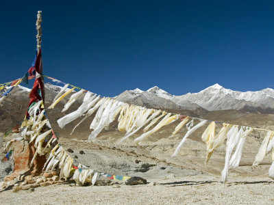 Prayer Flags And Snowy Peaks On A Pass Near Lo Monthang, Mustang by Stephen Sharnoff Pricing Limited Edition Print image