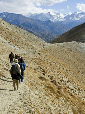 Hikers On A Trail Near Lo Monthang On The North Side Of The Himalayas by Stephen Sharnoff Pricing Limited Edition Print image