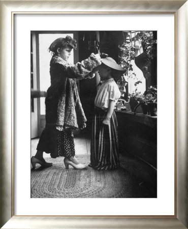 Children Trying On Old Clothes In The Attic, But Little Boy Would Prefer To Be Playing Football by Gordon Parks Pricing Limited Edition Print image