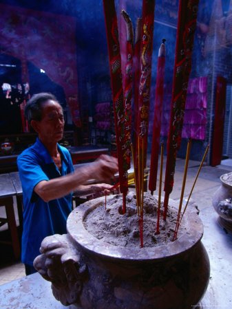 Man Making Incense Offerings In Temple, Vietnam by Mason Florence Pricing Limited Edition Print image