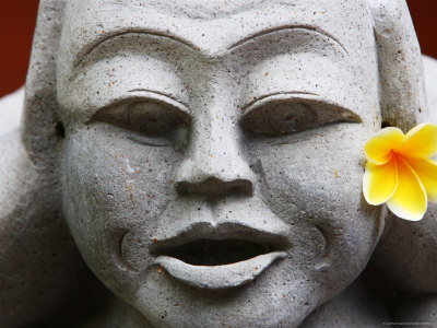 Frangipani Flower On A Stone Carved Face by Andrew Brownbill Pricing Limited Edition Print image
