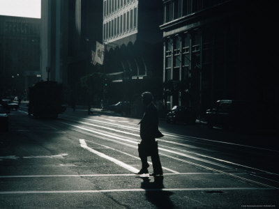 Man Crossing Street With Cable Car Looming In Background, San Francisco, California, Usa by Curtis Martin Pricing Limited Edition Print image