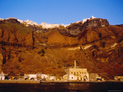 Buildings On Top Of And Below Volcanic Cliffs (Thira), Santorini Island, Greece by Jon Davison Pricing Limited Edition Print image