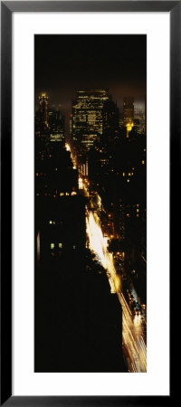 Skyscrapers In Manhattan Lit Up At Night, New York City, New York, Usa by Panoramic Images Pricing Limited Edition Print image