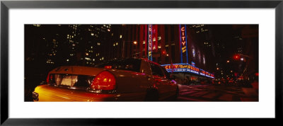 Car On A Road, Radio City Music Hall, Rockefeller Center, Manhattan, New York, Usa by Panoramic Images Pricing Limited Edition Print image