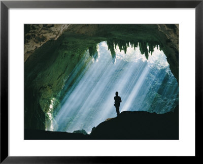 A Man Stands Below The Mouth Of A Giant Cave by David Boyer Pricing Limited Edition Print image