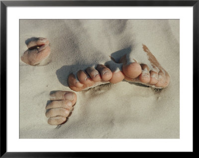 Two Pairs Of Feet Push Up Through The Sand by Jodi Cobb Pricing Limited Edition Print image