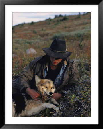 Portrait Of A Wrangler With His Pet Dog In Jasper National Park by Raymond Gehman Pricing Limited Edition Print image