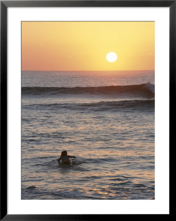 A Woman Paddles Out To Sea For Sunset Surfing by Jimmy Chin Pricing Limited Edition Print image