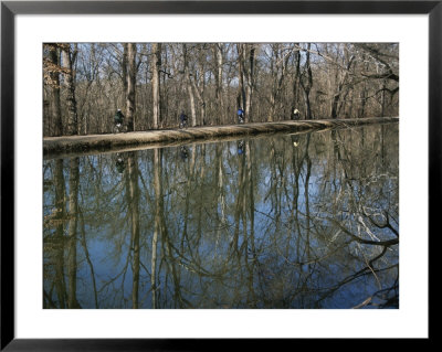 The C And O Canal Reflects Bikers Moving Along The Trail by Stephen St. John Pricing Limited Edition Print image