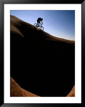 A Cyclist Riding On The Slick Rock Of Northern Arizona by Bill Hatcher Pricing Limited Edition Print image