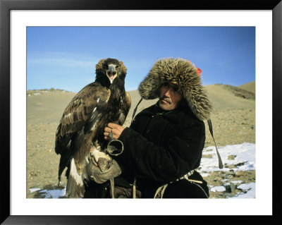 A Kazakh Eagle Hunter Poses With His Eagle On A Plain In Kazakhstan by Ed George Pricing Limited Edition Print image