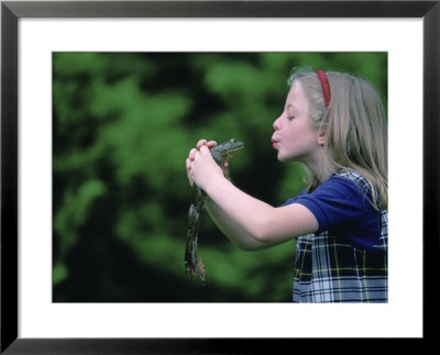 A Young Girl Plays Out A Fairy Tale As She Prepares To Kiss A Frog by Joel Sartore Pricing Limited Edition Print image