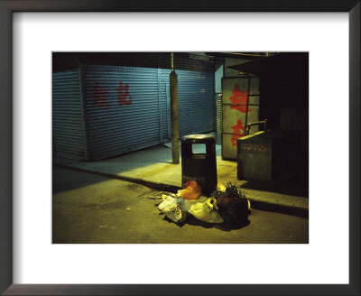 Pile Of Garbage Next To A Trash Can On A Hong Kong Street At Night by Eightfish Pricing Limited Edition Print image