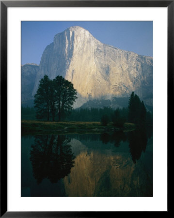 The Sunlit Face Of El Capitan Is Reflected In The Merced River by Phil Schermeister Pricing Limited Edition Print image