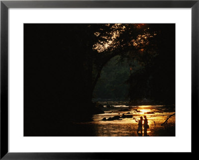 Backlit View Of Couple Flyfishing On The Potomac River At Sunset by Skip Brown Pricing Limited Edition Print image