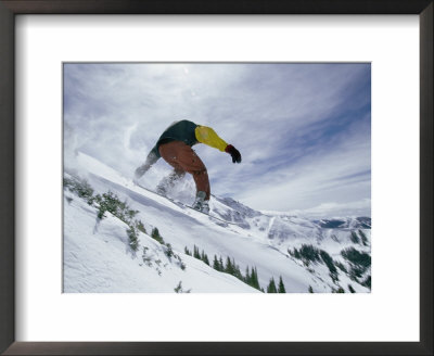 A Snowboarder Grabs The Back Edge Of His Board As He Goes Airborne by Paul Chesley Pricing Limited Edition Print image