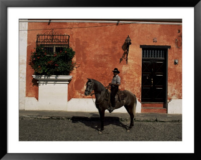 Man On Horse In Front Of A Typical Painted Wall, Antigua, Guatemala, Central America by Upperhall Pricing Limited Edition Print image
