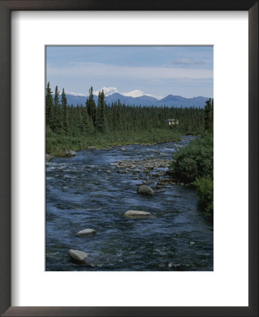 Mountain Stream With Cabin In Evergreen Forest In Distance by Rich Reid Pricing Limited Edition Print image