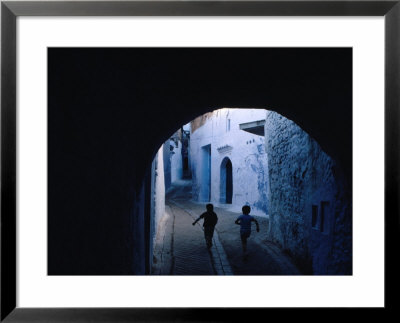 Two Boys Running Through Kasbah, Chefchaouen, Morocco by Jeffrey Becom Pricing Limited Edition Print image