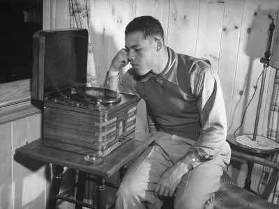 Heavyweight Boxing Champ Joe Louis, 26, Listens To Jimmy Lunceford Record At Training Camp by William C. Shrout Pricing Limited Edition Print image
