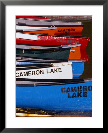 Canoes At Cameron Lake, Waterton Lakes National Park, Alberta, Canada by Lawrence Worcester Pricing Limited Edition Print image