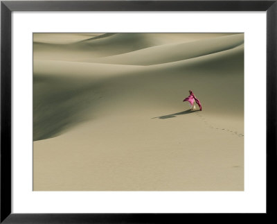 Lady With Flowing Fabric Standing In Sand Dunes And Casting A Shadow by Kate Thompson Pricing Limited Edition Print image