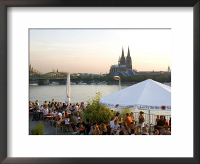 People At Trendy Rheinterrassen Bar And Restaurant Beside The River Rhine, Cologne, Germany by Yadid Levy Pricing Limited Edition Print image