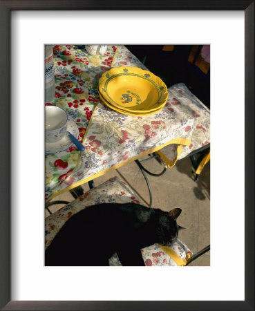 A Cat Lies On A Chair By A Table That Is Set For A Meal by Tino Soriano Pricing Limited Edition Print image